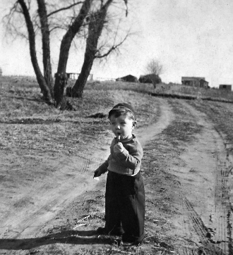 Larry as a young boy on a dirt road in Iowa
