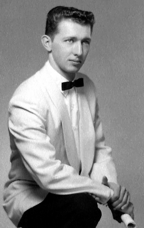 Young Larry in a white dinner jacket and bow tie
